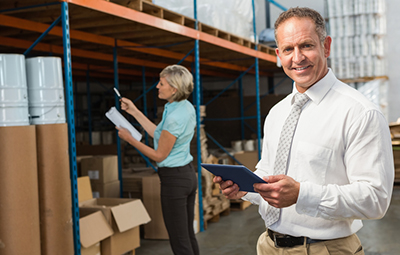 a warehouse manager smiling at work